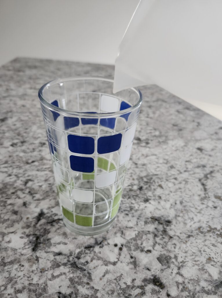 pitcher of water being poured into a glass cup