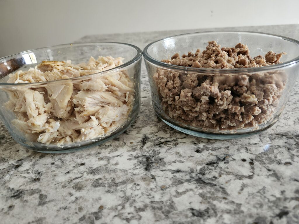 Glass container with chicken breast and lean ground beef