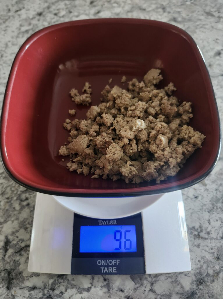 Lean ground beef being weighed out on a food scale