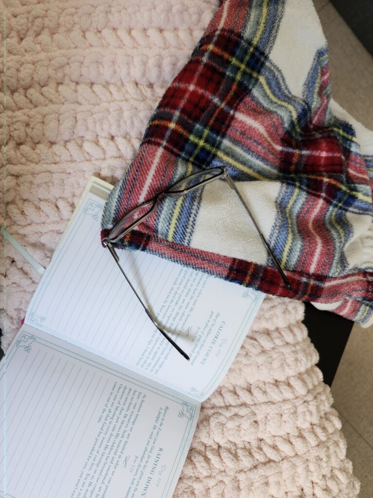 Cozy Sunday reset with fuzzy pajamas, blanket journal and glasses.
