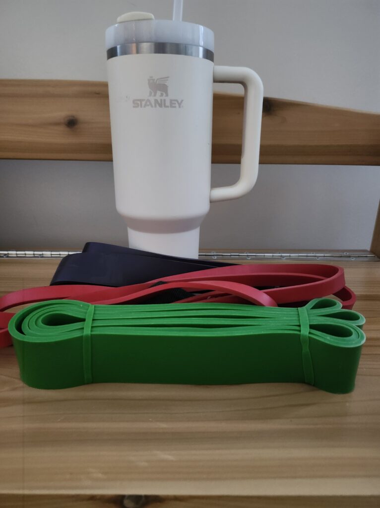 Resistance bands and watter bottle on a bench
