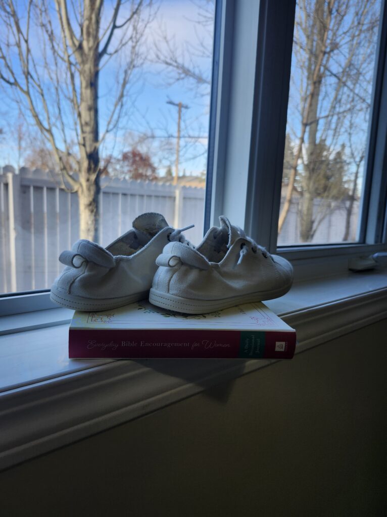 Shoes on a book on a bedroom window sill 