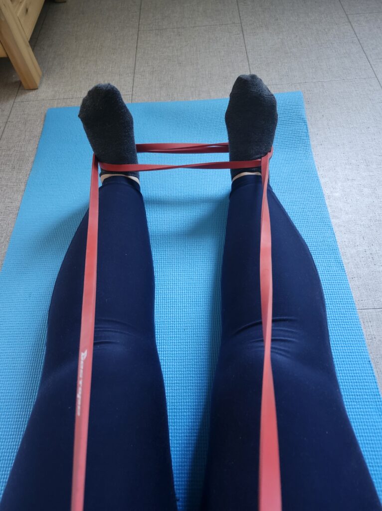 Stretching with bands on a blue mat