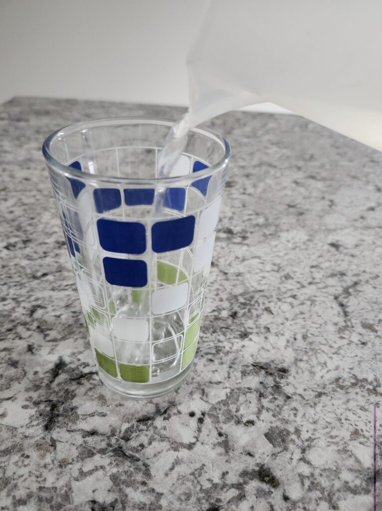Pouring water into a glass for some good hydration