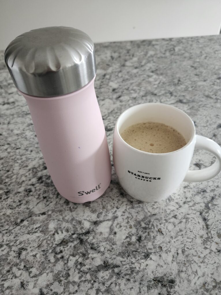 Staying hydrated with water in a water bottle and coffee on a counter