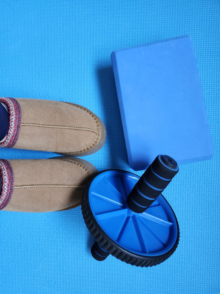 Cozy uggs to do some active recovery like yoga with a yoga block and ab roller