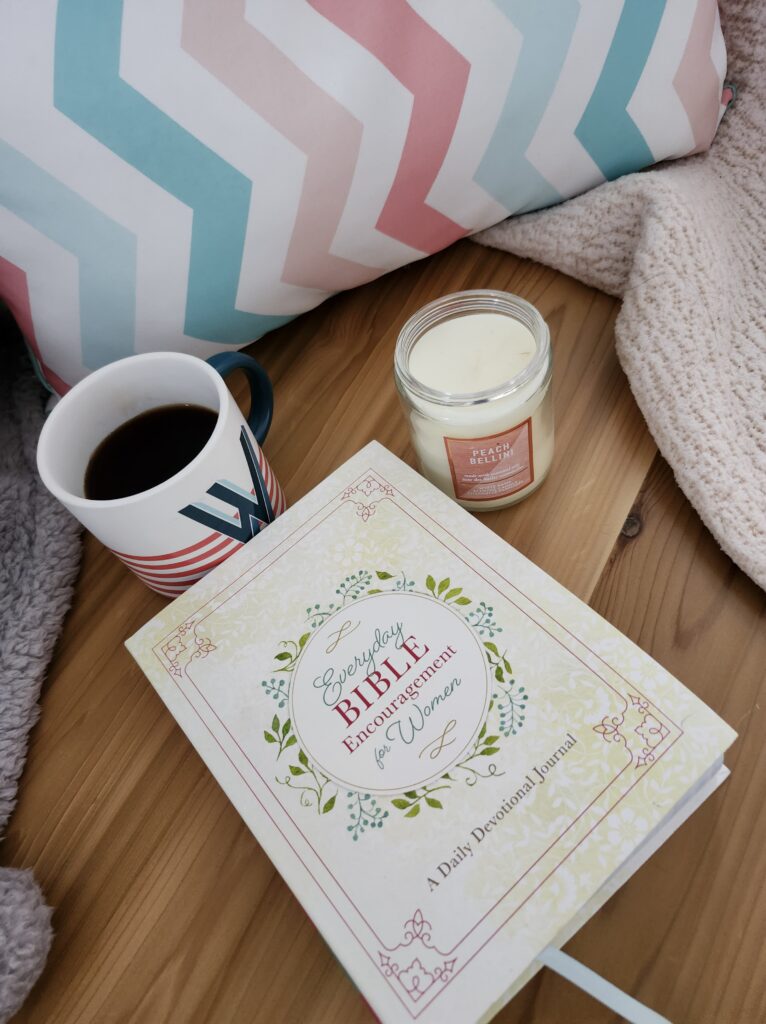 Relaxing on the couch with a cup of tea, journal and a candle