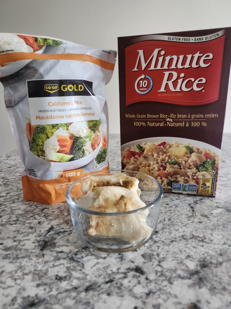 Prepping frozen vegetables, rice and chicken breast for a quick meal.