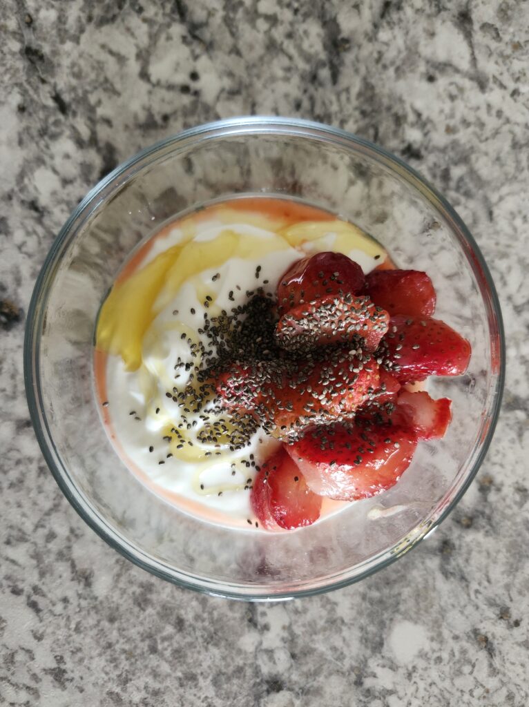 Greek yogurt bowl with strawberries, honey and chia seeds for a healthy protein snack