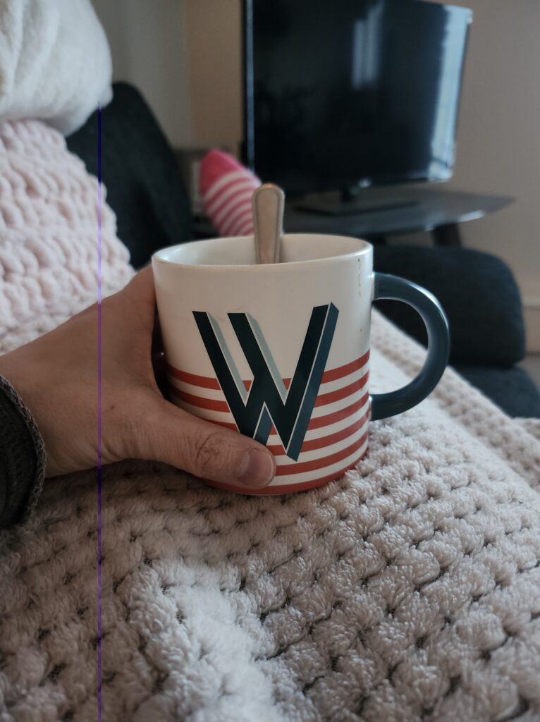 Resting on a couch with a blanket and some tea