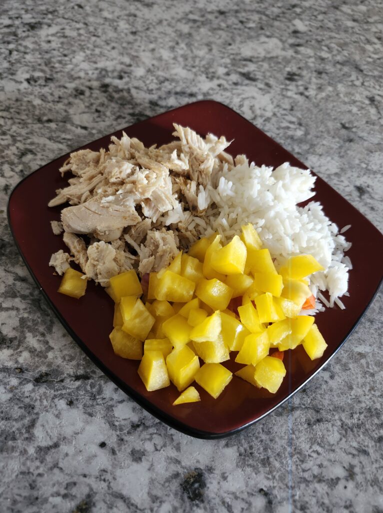 Healthy plate of chicken breast, rice and peppers for dinner