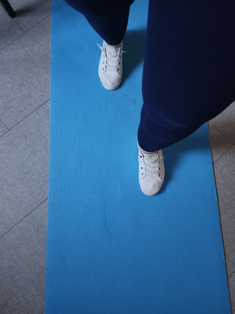 walking and stretching on a blue yoga mat